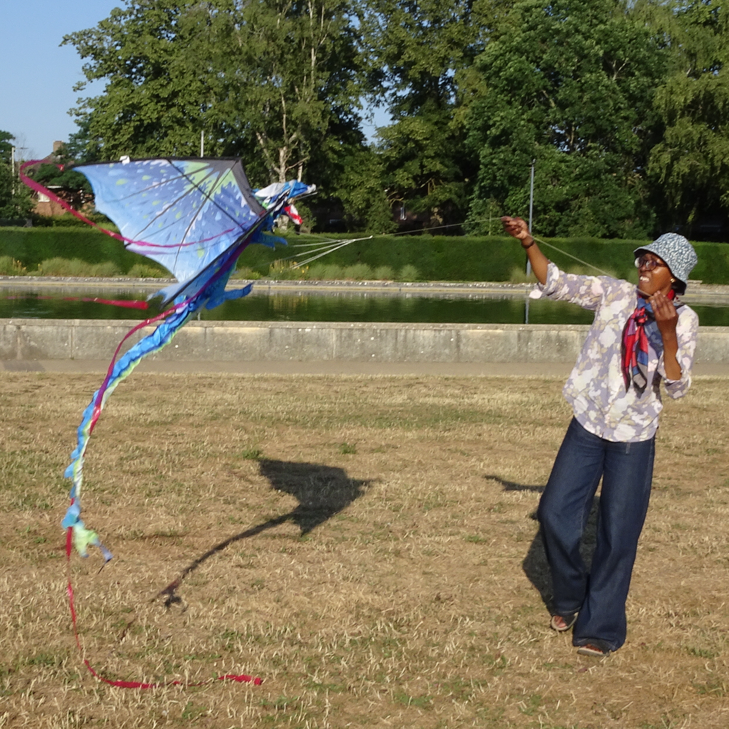 A woman launching a dragonfly kite.