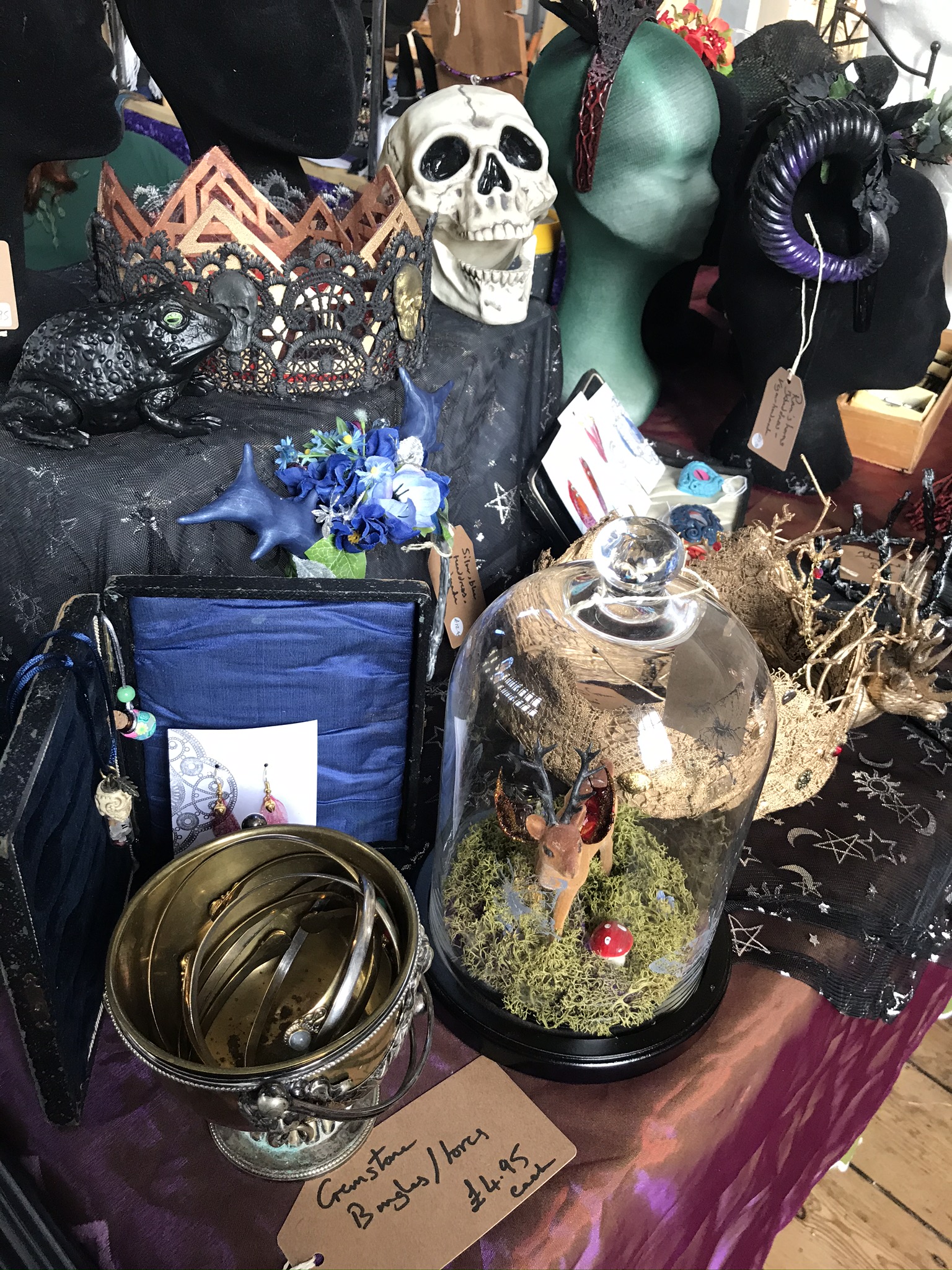 A treasury of goodies: a deer diorama in a bell jar, a brass cauldron of bangles, a resin skull, display head and much more!