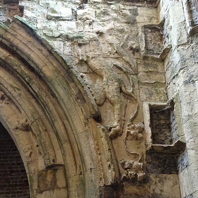The dragon or lion on the south spandrel of the inner gatehouse arch.
