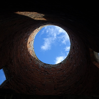 Looking up at the sky through the open top of the tower of the mill in Saint Benet's Abbey gatehouse - the sky looking like a world.