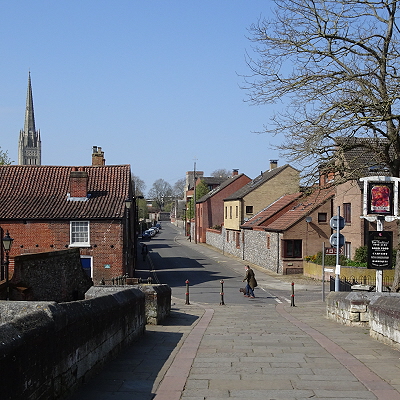 Bishopgate seen from Bishop's Bridge, with the Red Lion pub on the right and the Cathedral spire visible in the background on the left.