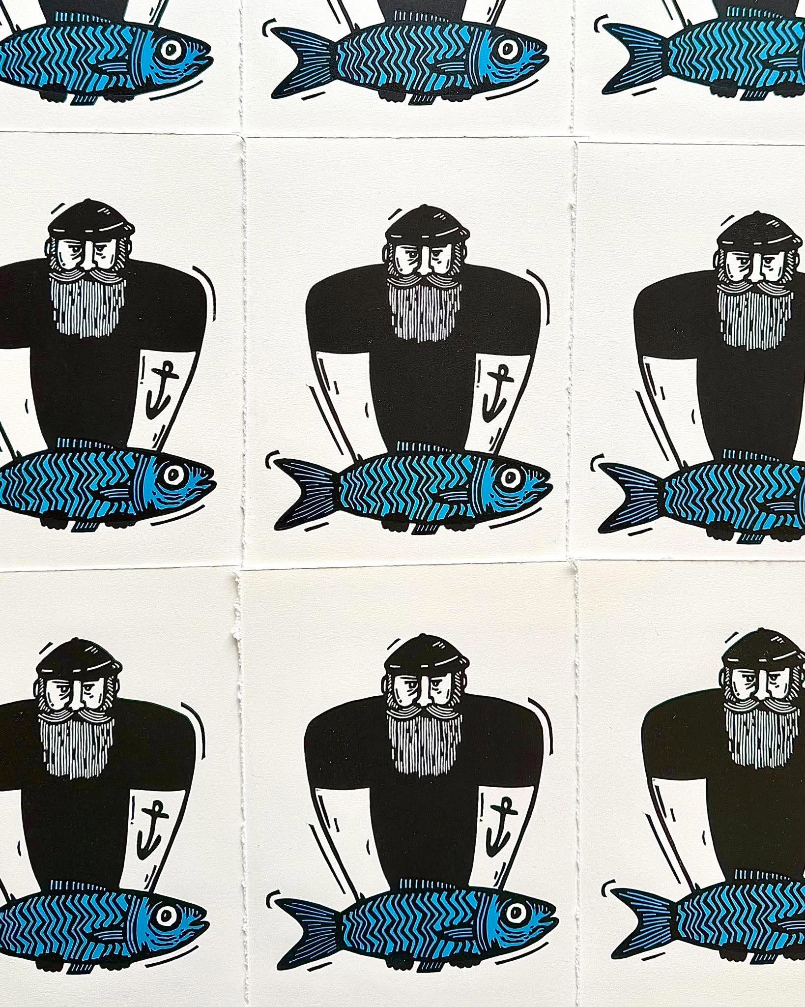 A linocut of a cat, a print of that design and a wooden spoon. Picture by Haychley Webb.