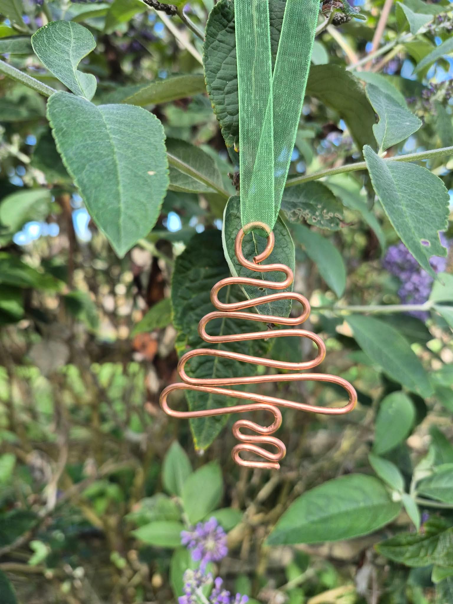 A copper-wire tree hung in a buddleia bush. Picture by Tina Hampton.